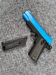 Cybergun BY-103892 Rail Gun Series Colt 1911 CO2 Blowback Pistol; Black / Silver; PTT Blue