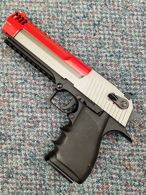 Cybergun BY-104451 Desert Eagle L6 .50AE CO2 GBB Pistol; FULL AUTO; Gun Metal Grey; PTT Red