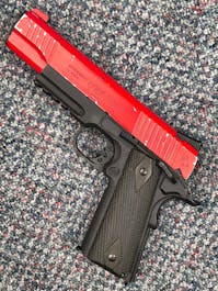 Cybergun BY-104904 Rail Gun Series Colt 1911 CO2 Blowback Pistol; Black/Silver; PTT Red